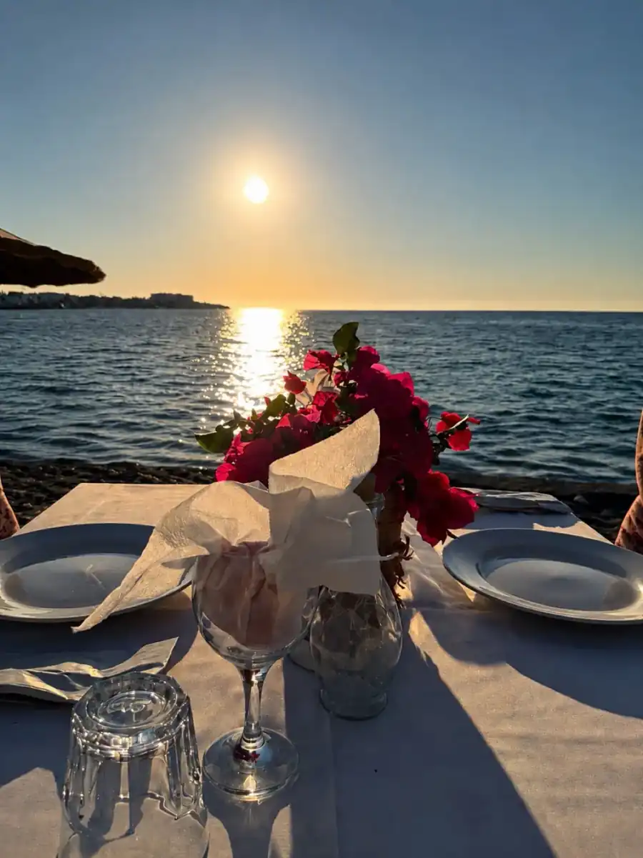 Restaurant table by the sea at sunset